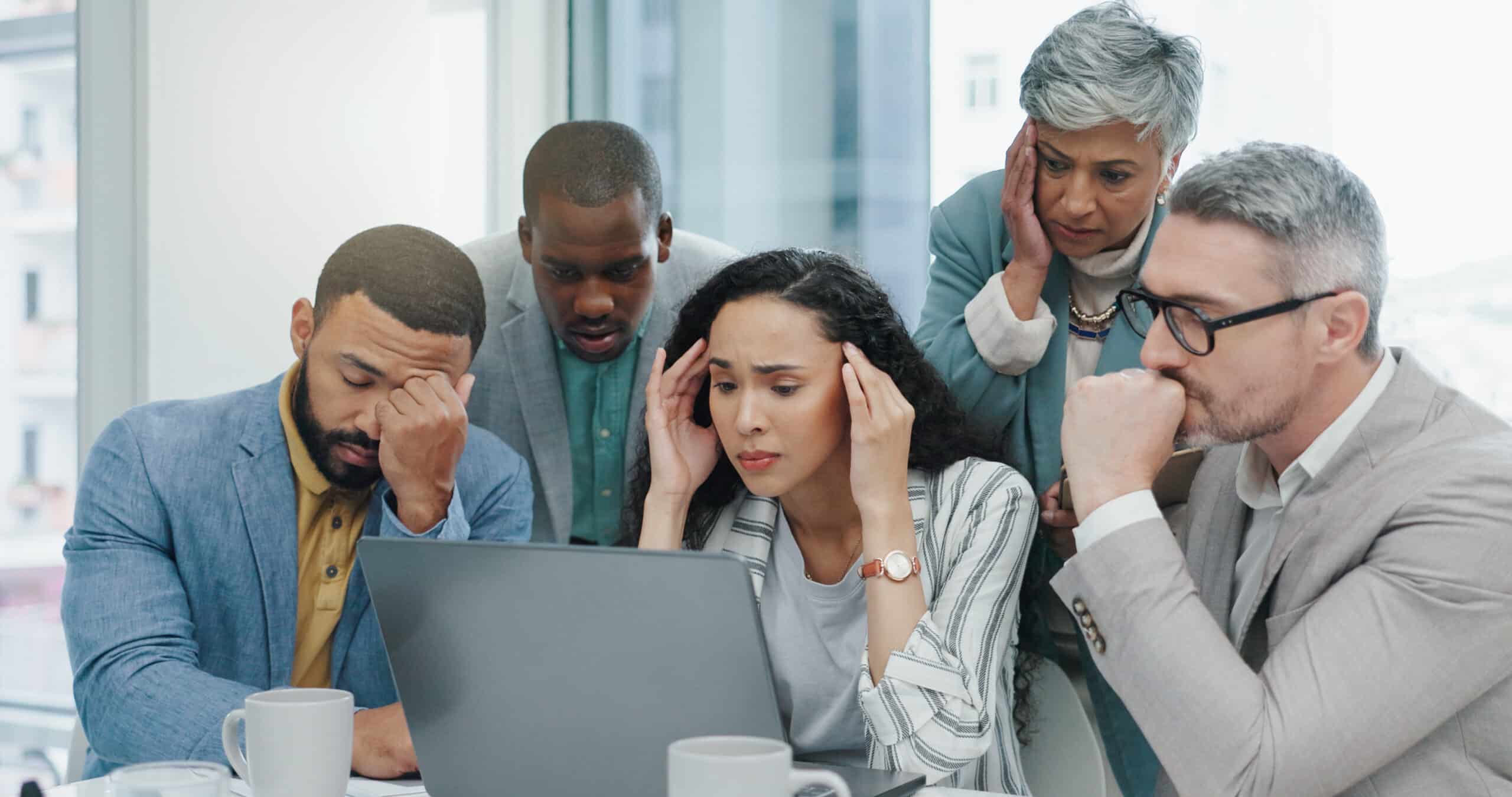 stressed team looking at laptop